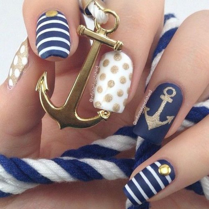 Navy nail art with anchor, stripes and polka dots in blue theme